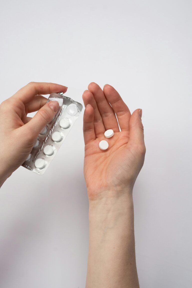 A hand holding chronic pain meds.